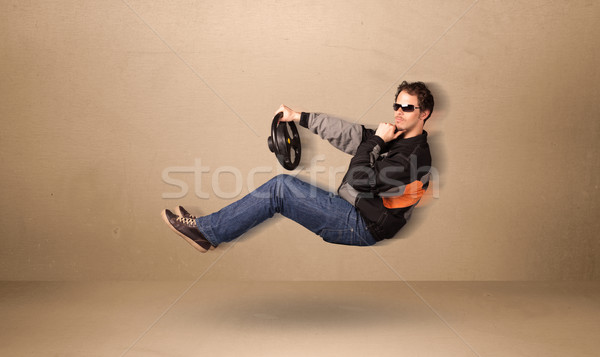 Happy funny man driving a flying car concept Stock photo © ra2studio