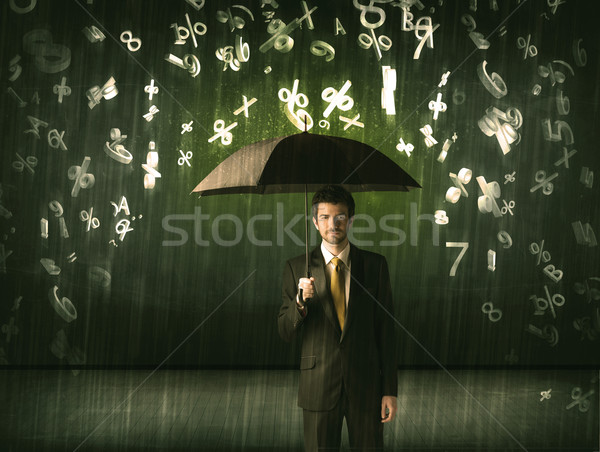 Stock photo: Businessman standing with umbrella and 3d numbers raining concep