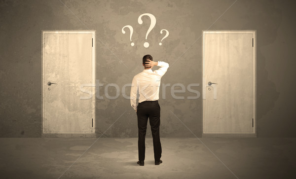 Businessman standing in front of doors Stock photo © ra2studio