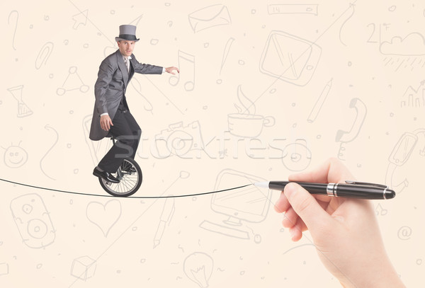 Businessman riding monocycle on a rope drawn by hand Stock photo © ra2studio