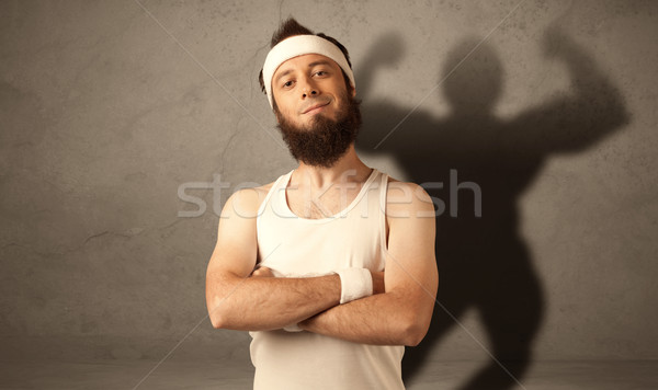 Stock photo: Skinny man with musculous shadow