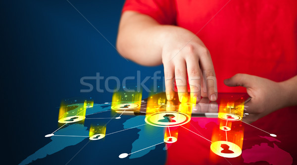 Hand holding tablet device with social network map Stock photo © ra2studio