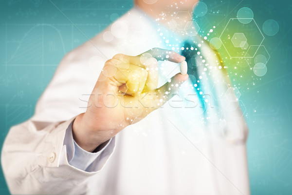 A doctor in tie holding a pill Stock photo © ra2studio