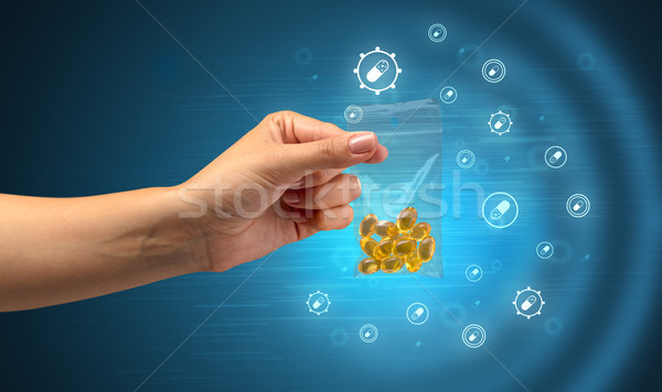 Színes kéz tabletták kicsi műanyag táska Stock fotó © ra2studio