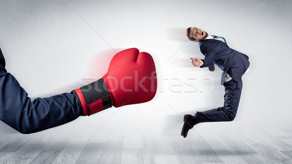 Red boxing glove knocks out little businessman Stock photo © ra2studio