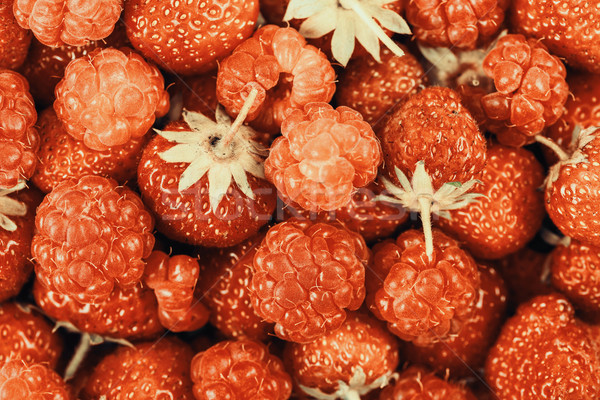 Raspberry And Strawberry Pile In Fruit Market Stock photo © radub85