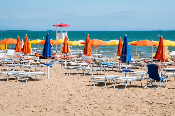 [[stock_photo]]: Ensoleillée · plage · plage · de · sable · coloré · parapluies · chaises