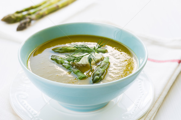 Asparagus soup in a bowl with fresh cream and dill Stock photo © rafalstachura