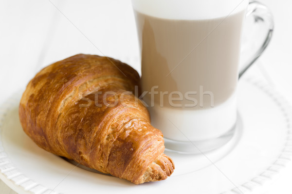 Croissant and glass of latte coffee on white plate Stock photo © rafalstachura