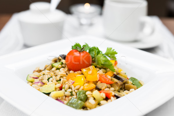 Pearl barley porridge with vegetables on square plate Stock photo © rafalstachura