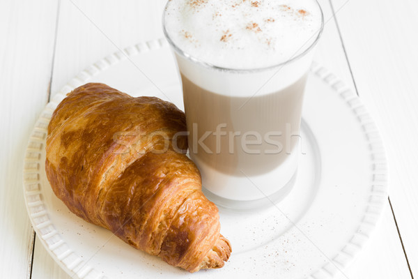 Croissant and glass of latte macchiato on white plate Stock photo © rafalstachura