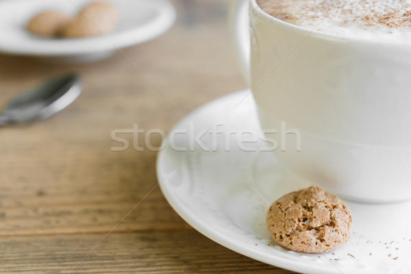 Cup of cafe latte with biscotti on wooden table Stock photo © rafalstachura
