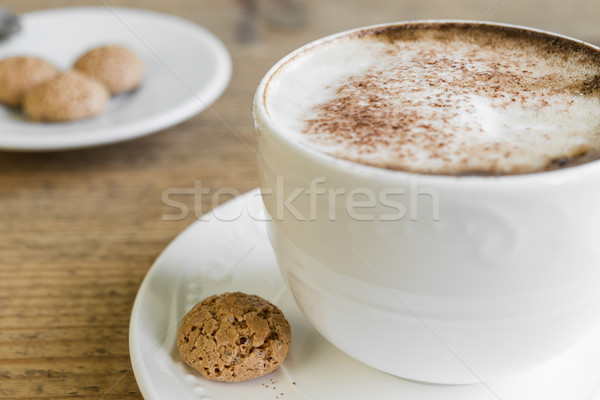 Cup of latte macchiato with biscotti on wooden table Stock photo © rafalstachura