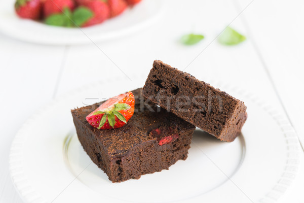 Chocolate brownie cake on white plate decorated with strawberrie Stock photo © rafalstachura