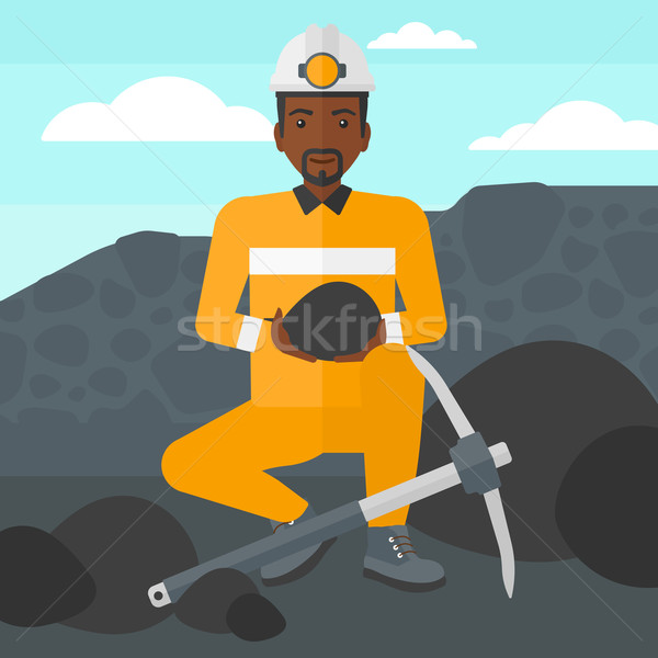 Miner holding coal in hands. Stock photo © RAStudio