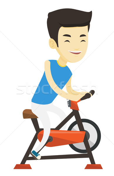 Fiatalember lovaglás mozdulatlan bicikli ázsiai férfi Stock fotó © RAStudio