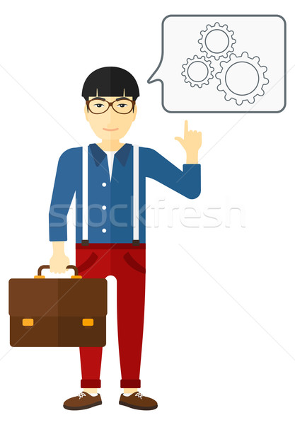 Businessman pointing at cogwheels. Stock photo © RAStudio