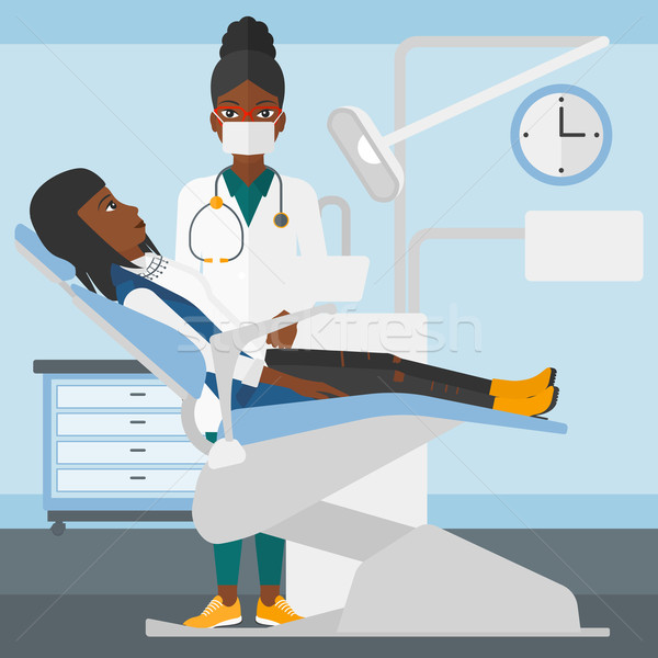 Dentist and woman in dentist chair. Stock photo © RAStudio
