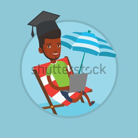Graduate lying in chaise lounge with a laptop. Stock photo © RAStudio