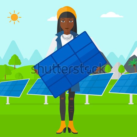 Stock photo: Man with solar panels and wind turbines.