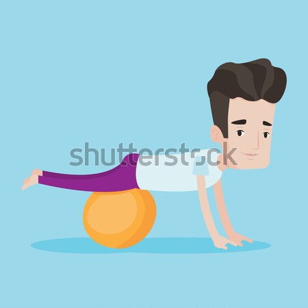 Stock photo: Young man exercising with fitball.