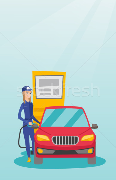 Stock photo: Worker filling up fuel into car.
