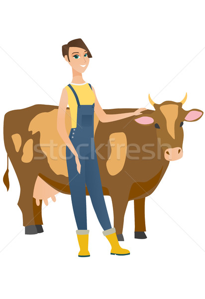 Farmer standing with crossed arms near cow. Stock photo © RAStudio