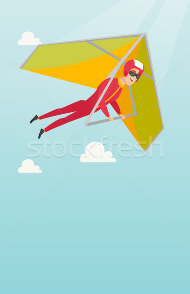 Young caucasian man flying on hang-glider. Stock photo © RAStudio