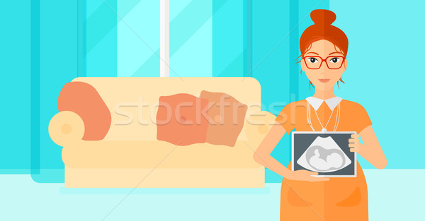 Stock photo: Pregnant woman with ultrasound image.