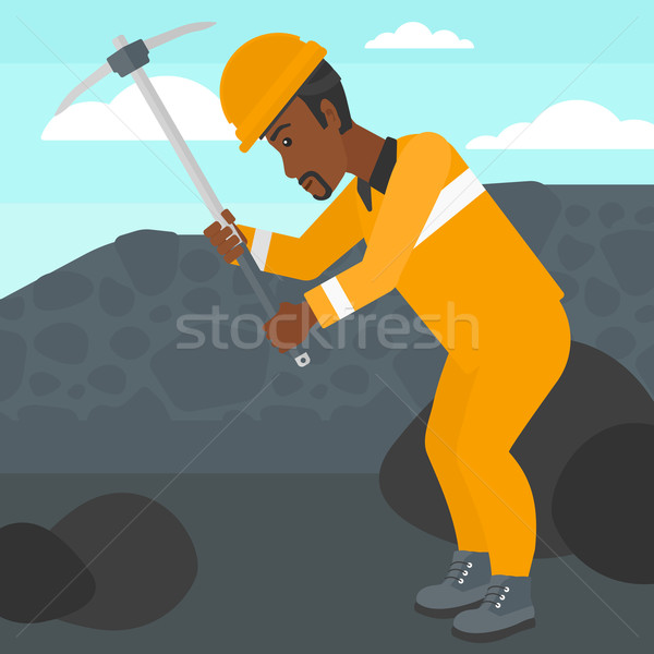 Stock photo: Miner working with pick.