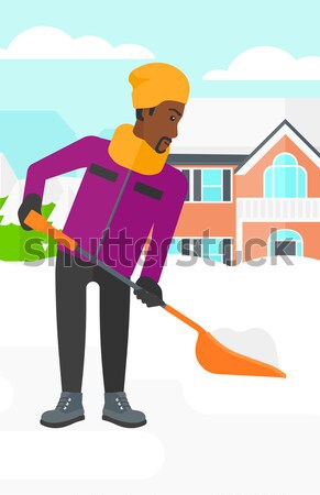 Stock photo: Man shoveling and removing snow.