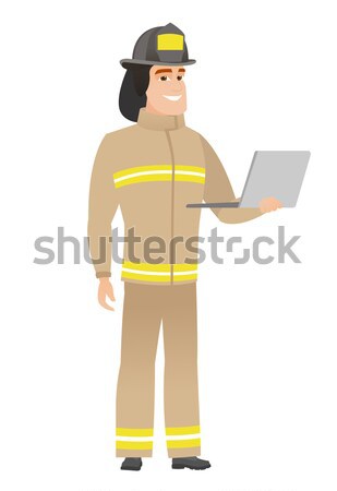 Firefighter with clipboard giving thumb up. Stock photo © RAStudio