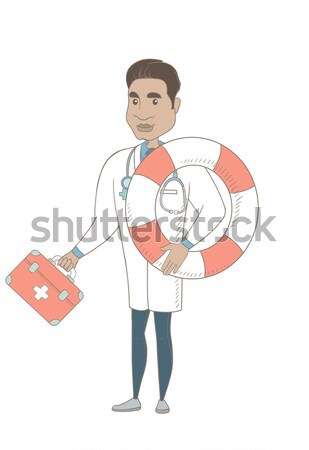 Stock photo: Paramedic running with first aid box and lifebuoy.