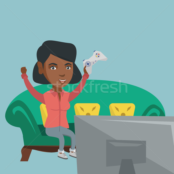 Stock photo: Young african-american woman playing video game.