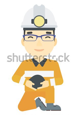 Stock photo: Miner holding coal in hands.