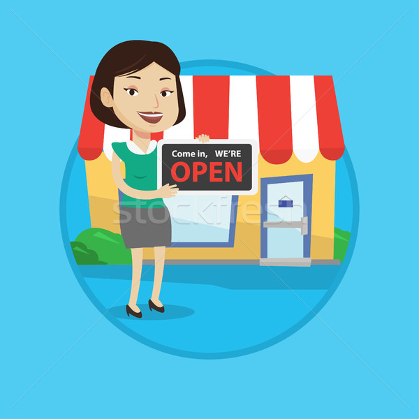 Female shop owner holding open signboard. Stock photo © RAStudio