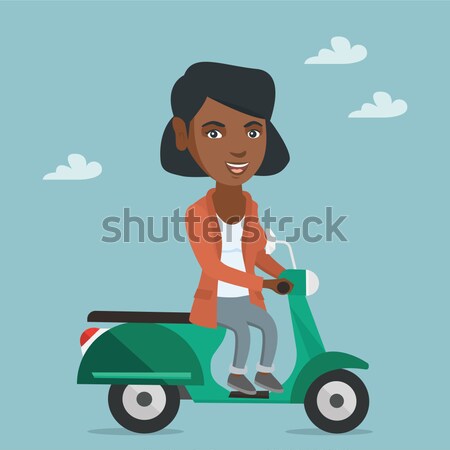 Young african-american man riding scooter. Stock photo © RAStudio