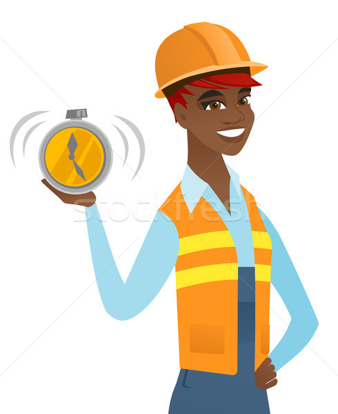 Young african-american builder holding alarm clock Stock photo © RAStudio