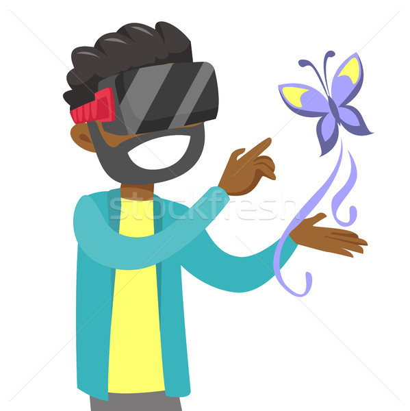 Stock photo: Black man in VR headset uses augmented technology.