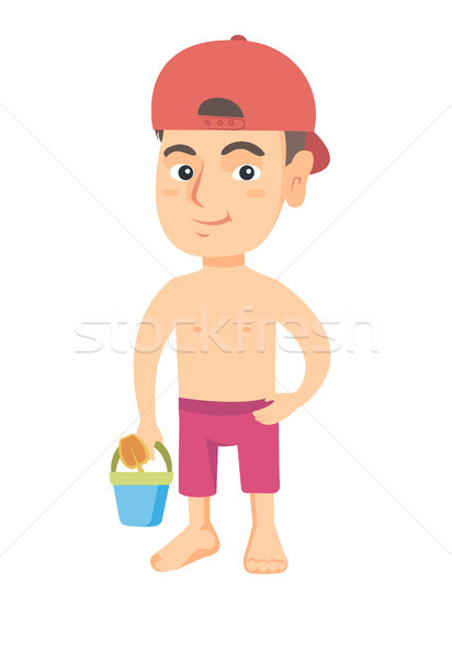 Caucasian boy in shorts holding pail and shovel. Stock photo © RAStudio