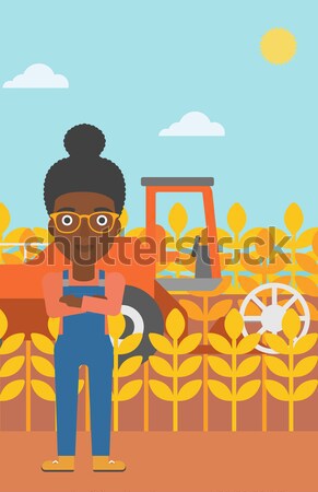 Stock photo: Man with tablet computer on field.