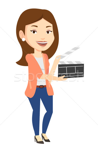 Smiling woman holding an open clapperboard. Stock photo © RAStudio