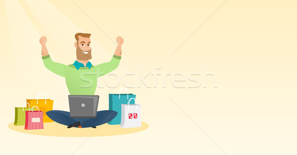 Caucasian man using a laptop for online shopping. Stock photo © RAStudio