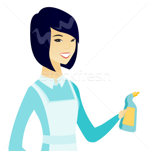 Young asian cleaner in uniform holding detergent. Stock photo © RAStudio
