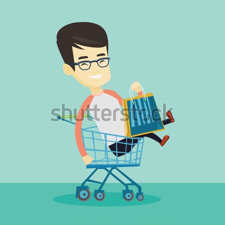 Happy man riding by shopping trolley. Stock photo © RAStudio