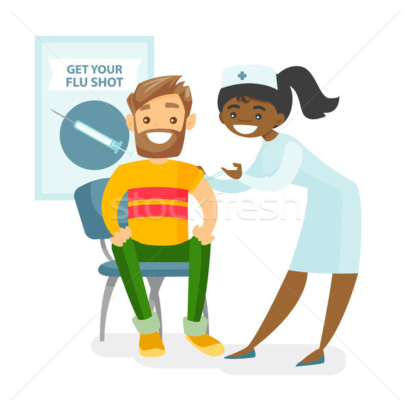 Doctor giving a free flu vaccination to a patient. Stock photo © RAStudio