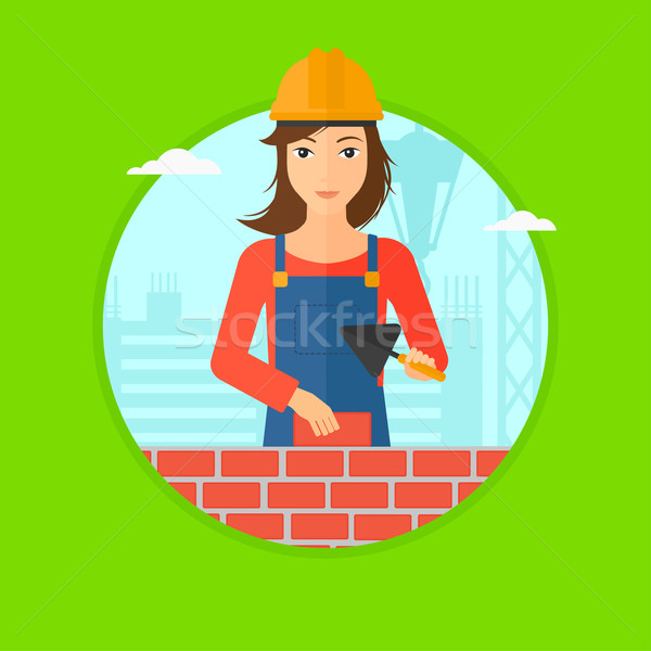 Bricklayer with spatula and brick. Stock photo © RAStudio