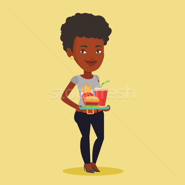 Woman holding tray full of fast food. Stock photo © RAStudio