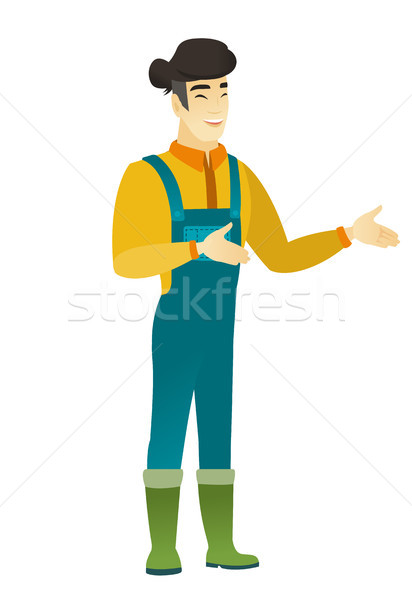 Young asian happy farmer gesturing. Stock photo © RAStudio