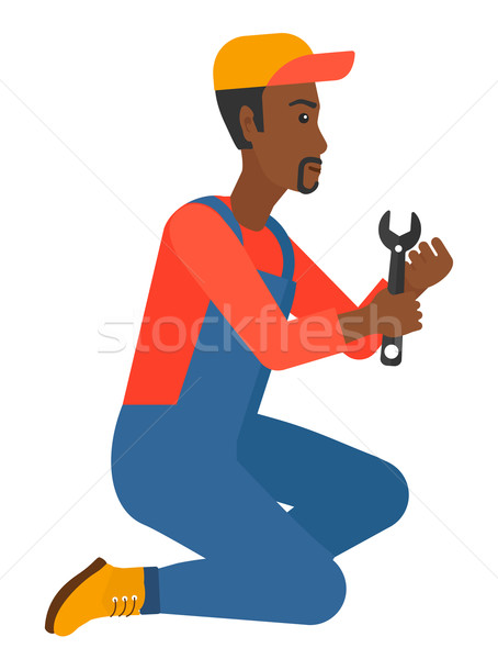 Repairman holding spanner. Stock photo © RAStudio